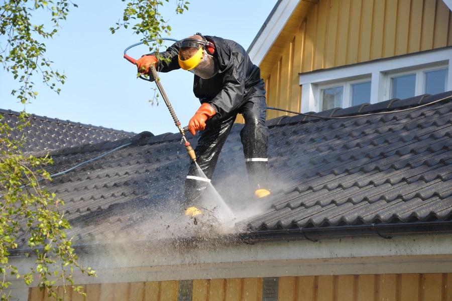 Cleaning house gutters removing leaves and debris in Aurora Illinois